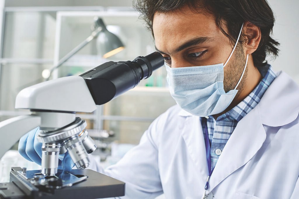 Closeup Young Clinician Protective Mask Studying New Virus Bacteria